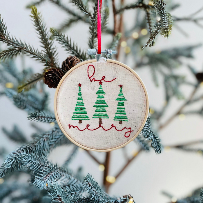 





This ornament is a unique and handcrafted piece, featuring a beautiful embroidered design that reads "Be Merry." The design is meticulously stitched onto a pie