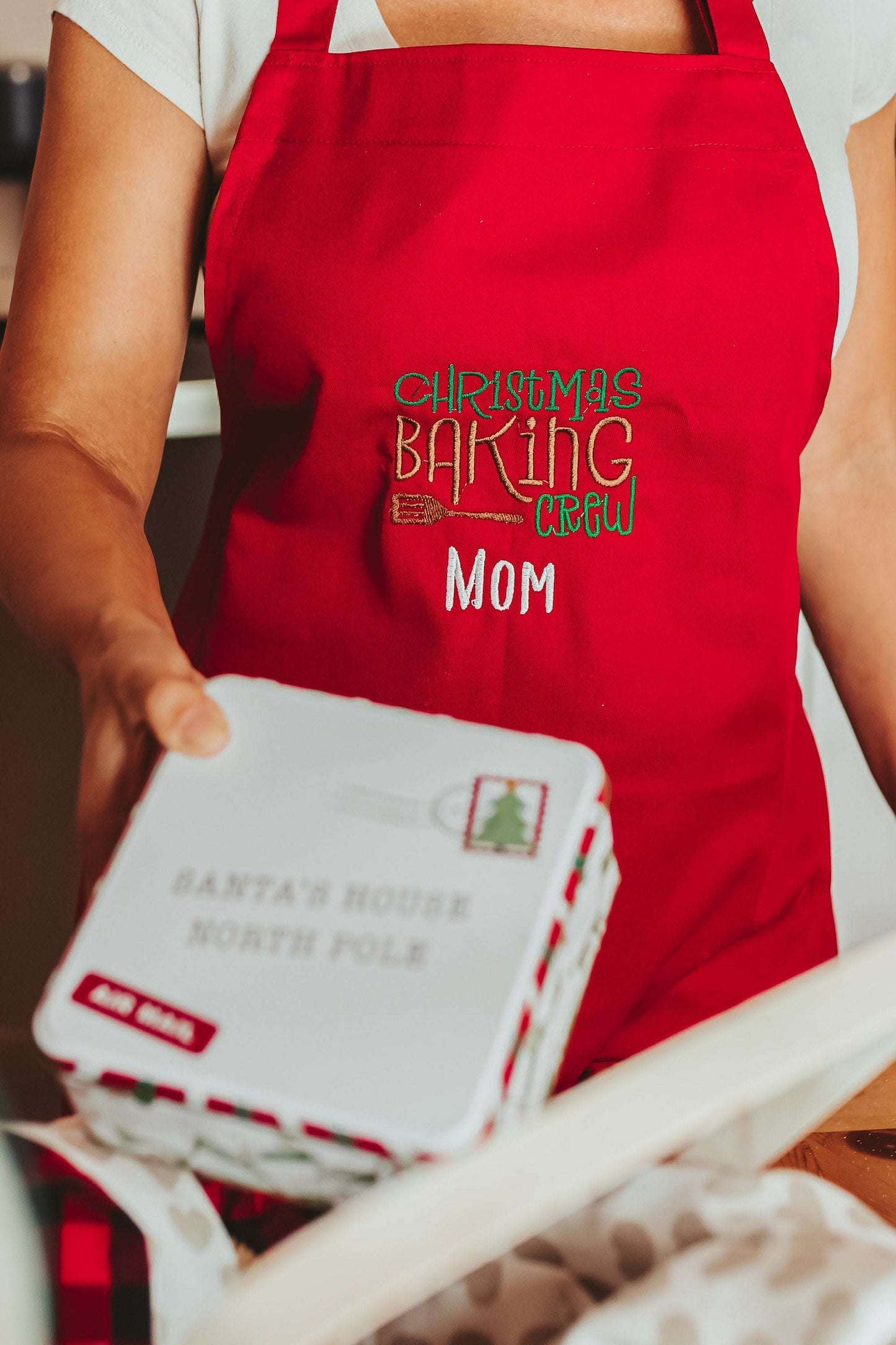 Product Details
The red Christmas baking apron for adults is the perfect accessory for all your holiday baking needs. The apron features an embroidered design that