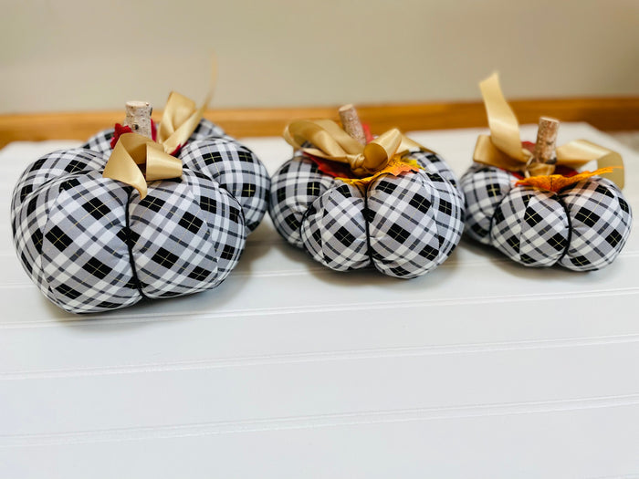  
Introducing our set of 3 fabric pumpkins, available in large, medium, and small sizes. These pumpkins are made from a unique black, white and gold plaid fabric, ad