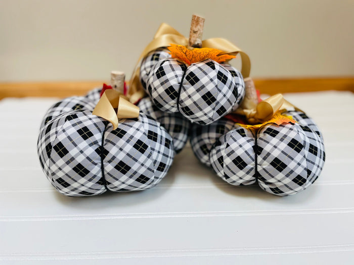  
Introducing our set of 3 fabric pumpkins, available in large, medium, and small sizes. These pumpkins are made from a unique black, white and gold plaid fabric, ad