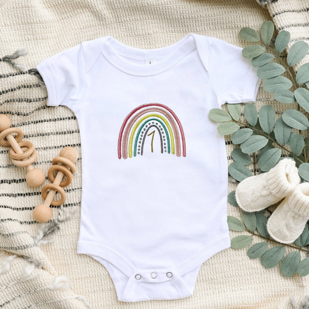 A rainbow short sleeves Onesie®. Features a 1 for a first birthday.