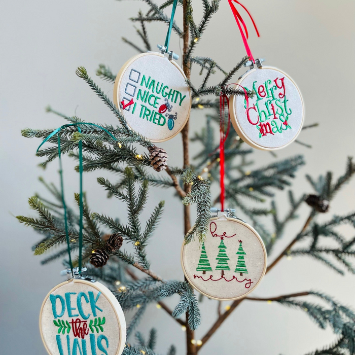 





This ornament is a unique and handcrafted piece, featuring a beautiful embroidered design that reads "Be Merry." The design is meticulously stitched onto a pie