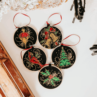 Add a touch of luxurious elegance to your home’s holiday decorations. These beautiful ornaments are embroidered on black fabric and feature metallic embroidery threa