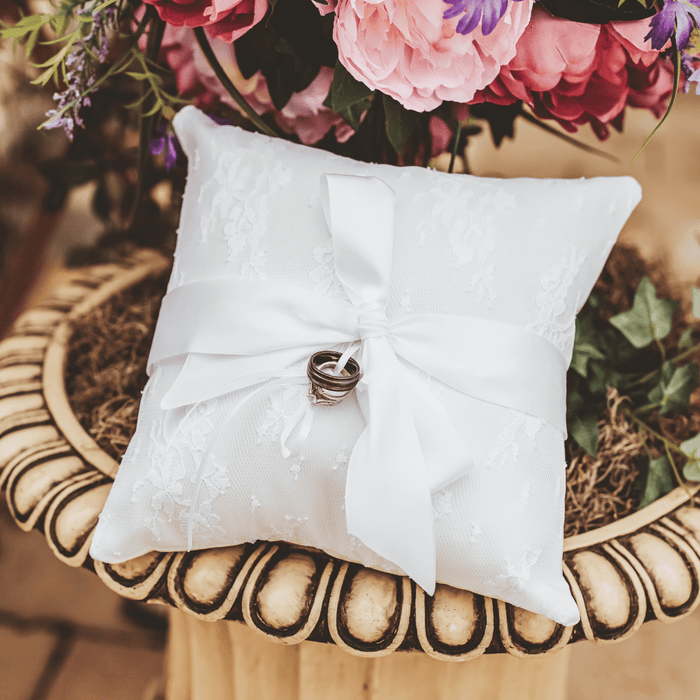 Beautiful ring pillow will be the perfect addition to your wedding. This simple but elegant ring pillow is made with white satin. Features a lace overlay and satin r