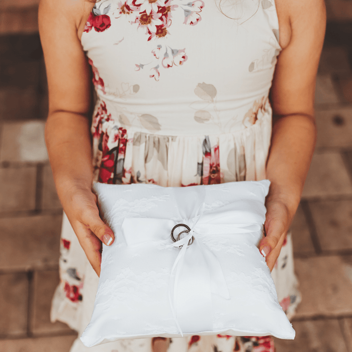 Beautiful ring pillow will be the perfect addition to your wedding. This simple but elegant ring pillow is made with white satin. Features a lace overlay and satin r