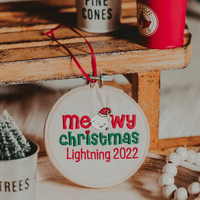 This ornament is perfect for the cat lover in your life! It features an embroidered design of a cat and the words "Meowy Christmas" in an embroidery hoop. The orname