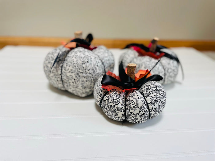 Introducing our set of 3 fabric pumpkins, available in large, medium, and small sizes. These pumpkins are made from a unique black and white swirled fabric, adding a