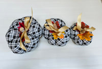  
Introducing our set of 3 fabric pumpkins, available in large, medium, and small sizes. These pumpkins are made from a unique black, white and gold plaid fabric, ad