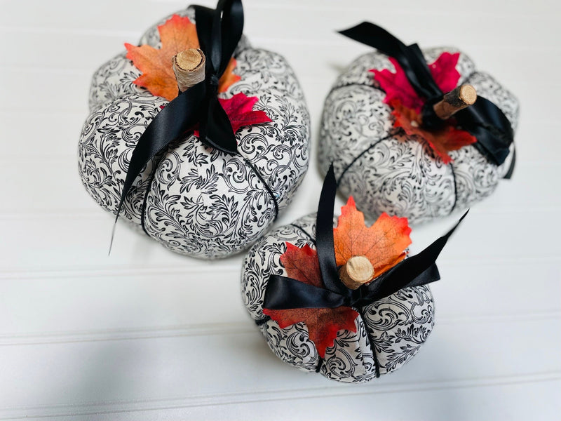Introducing our set of 3 fabric pumpkins, available in large, medium, and small sizes. These pumpkins are made from a unique black and white swirled fabric, adding a