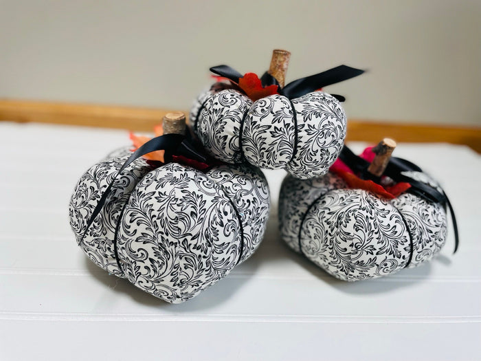 Introducing our set of 3 fabric pumpkins, available in large, medium, and small sizes. These pumpkins are made from a unique black and white swirled fabric, adding a