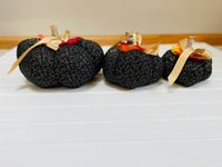 Introducing our set of 3 fabric pumpkins, available in large, medium, and small sizes. These pumpkins are made from a unique black and gold swirled fabric, adding a 