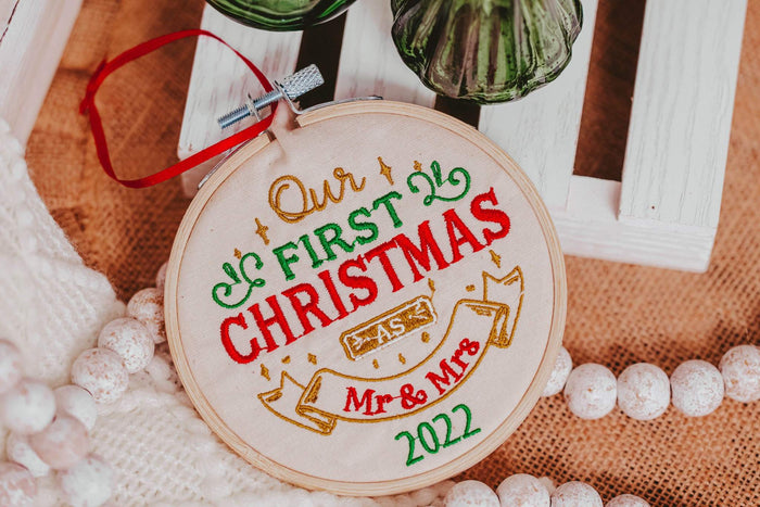 Celebrate your first Christmas together with this beautiful ornament. This machine embroidered ornament features a traditional design and the year of your wedding, m