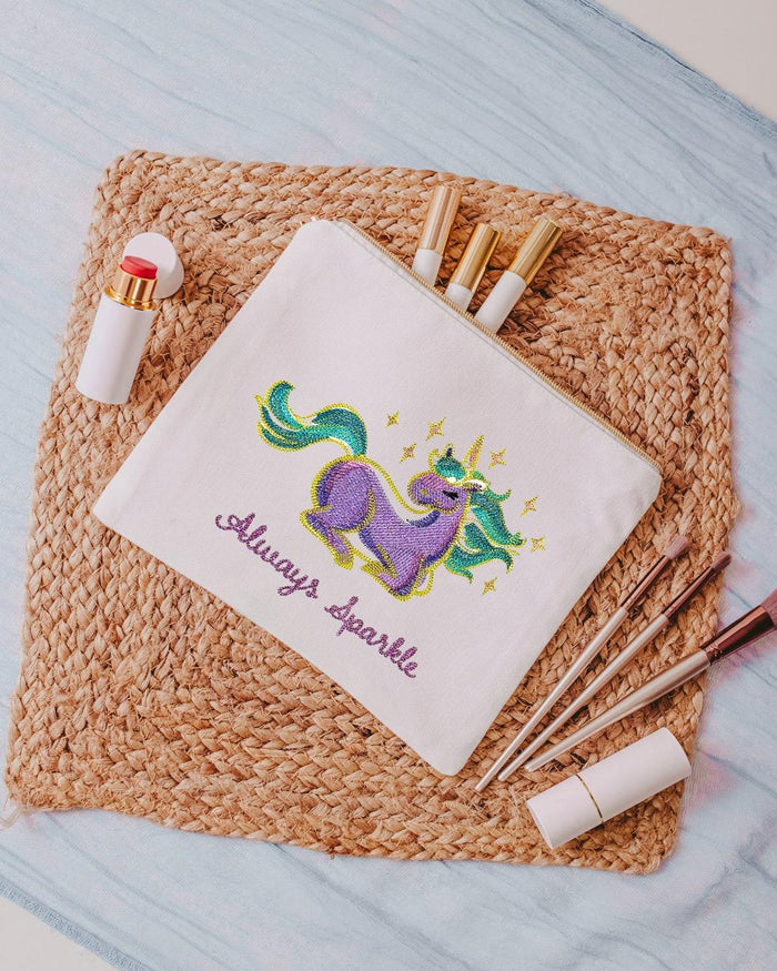Introducing our white canvas cosmetic bag, perfect for keeping all your beauty essentials organized on the go. Measuring 10.5" x 8" x 1", this bag features a colorfu